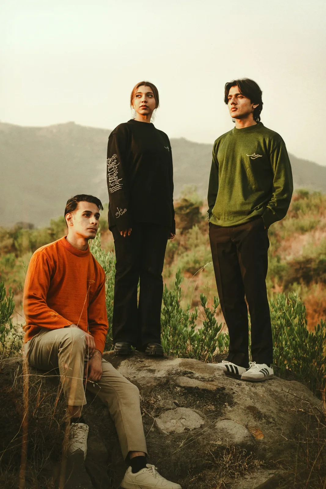 Sagar Shabbir walking through arched corridor holding umbrella