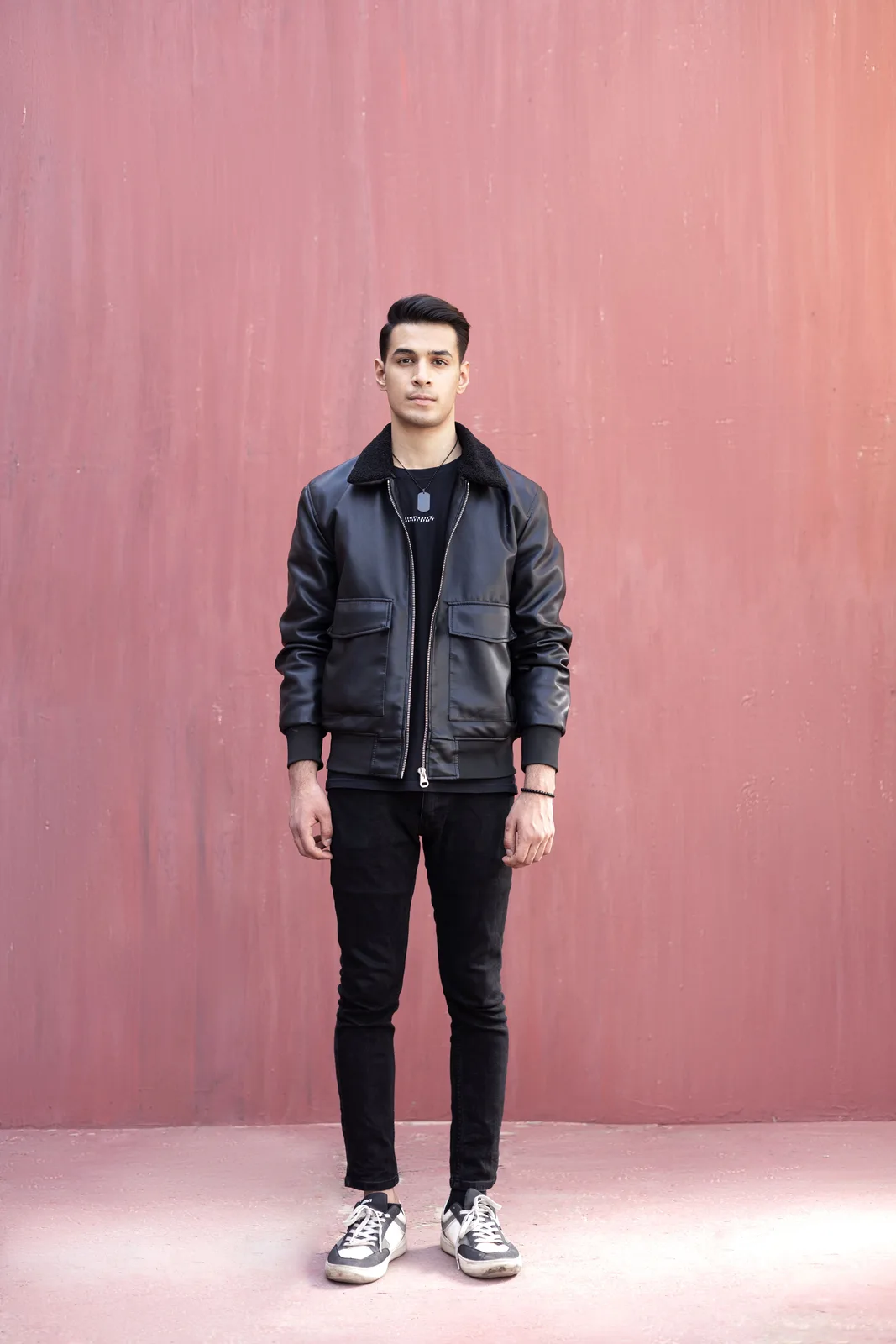 Sagar Shabbir full-length standing centered, leather jacket