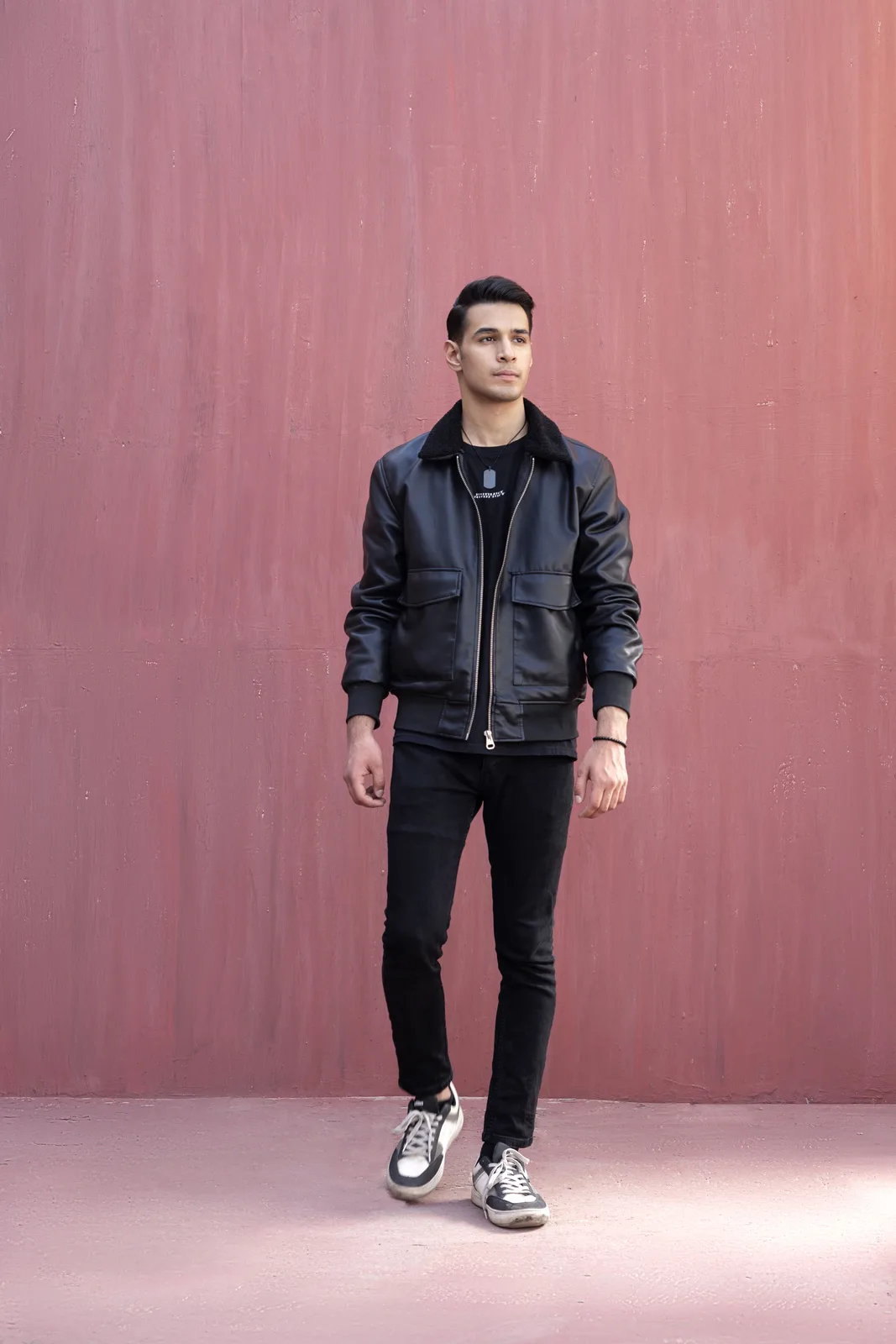 Sagar Shabbir full-length, standing in leather jacket