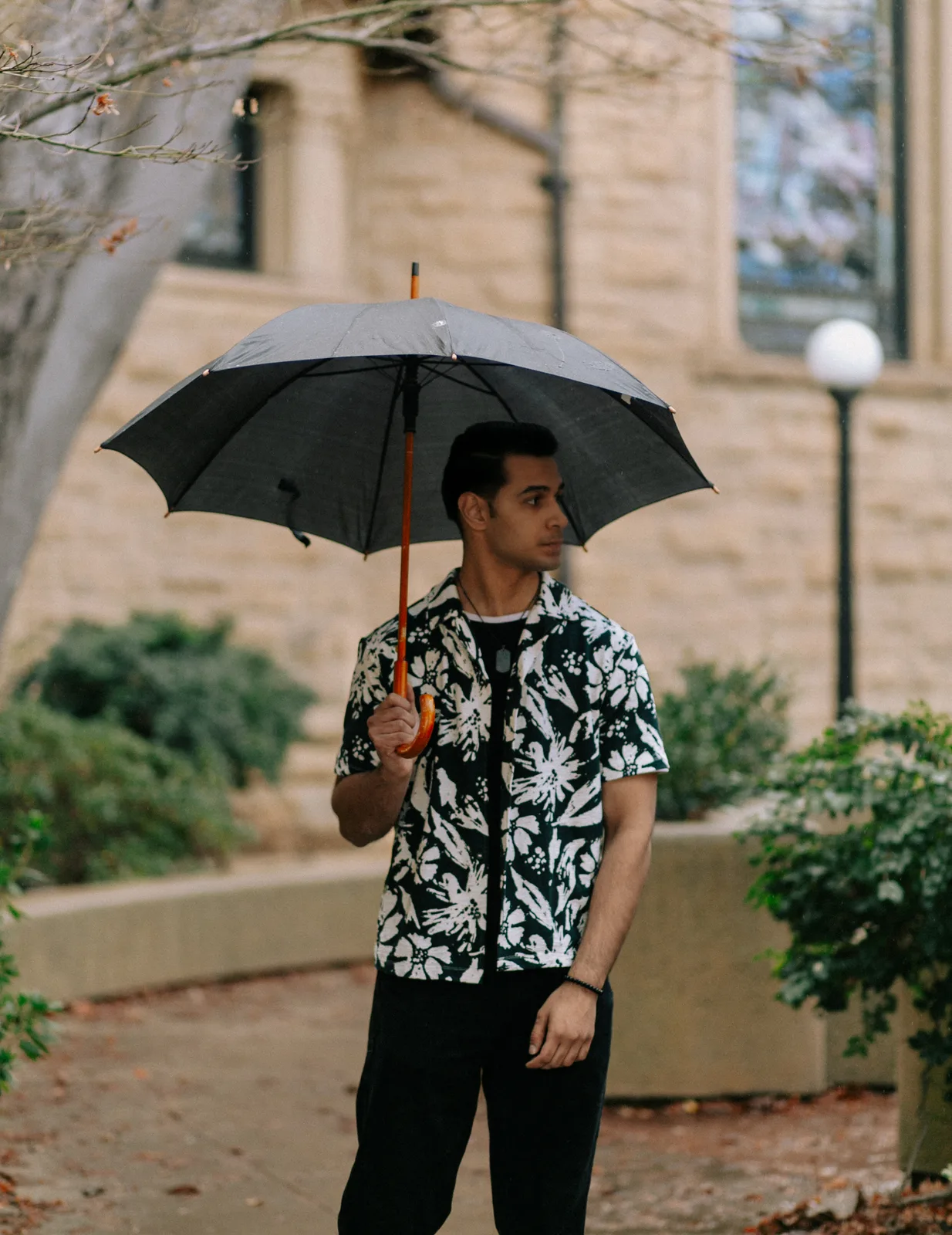 Sagar Shabbir outdoor editorial with umbrella and floral shirt
